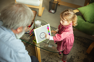 Image showing Grandfather and child playing together at home. Happiness, family, relathionship, education concept.