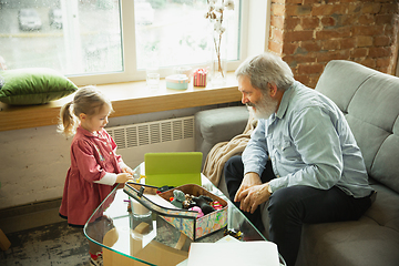 Image showing Grandfather and child playing together at home. Happiness, family, relathionship, education concept.