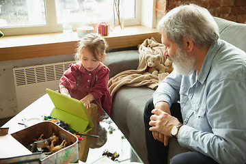 Image showing Grandfather and child playing together at home. Happiness, family, relathionship, education concept.