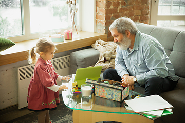 Image showing Grandfather and child playing together at home. Happiness, family, relathionship, education concept.