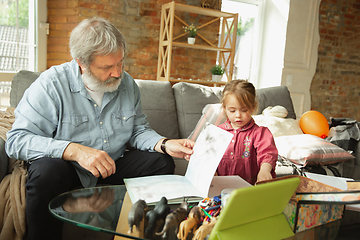 Image showing Grandfather and child playing together at home. Happiness, family, relathionship, education concept.