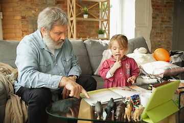 Image showing Grandfather and child playing together at home. Happiness, family, relathionship, education concept.