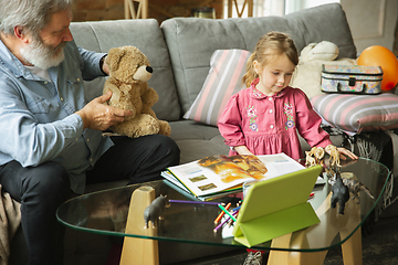 Image showing Grandfather and child playing together at home. Happiness, family, relathionship, education concept.