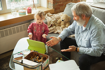 Image showing Grandfather and child playing together at home. Happiness, family, relathionship, education concept.