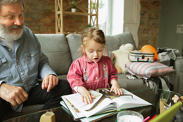 Image showing Grandfather and child playing together at home. Happiness, family, relathionship, education concept.