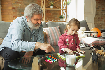 Image showing Grandfather and child playing together at home. Happiness, family, relathionship, education concept.