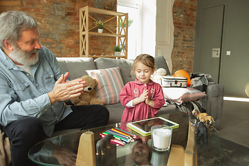 Image showing Grandfather and child playing together at home. Happiness, family, relathionship, education concept.