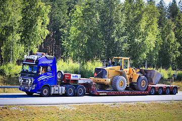 Image showing Volvo FH16 Truck Hauls Volvo Wheel Loader on Semi Trailer