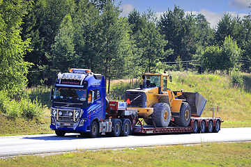 Image showing Volvo FH16 Truck Hauls Volvo Wheel Loader on Semi Trailer