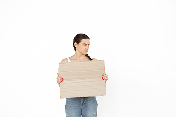 Image showing Young woman protesting with blank board, sign isolated on white studio background