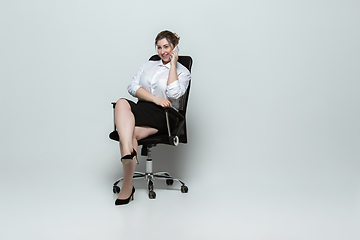 Image showing Young caucasian woman in office attire on gray background. Bodypositive female character. plus size businesswoman