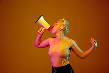 Image showing Portrait of young caucasian woman in fashionable eyewear on brown background with copyspace, unusual and freaky appearance