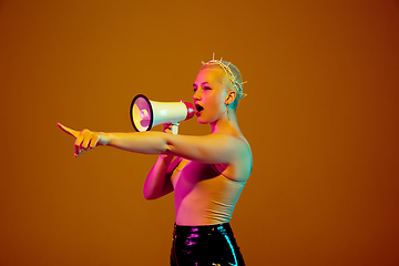 Image showing Portrait of young caucasian woman in fashionable eyewear on brown background with copyspace, unusual and freaky appearance