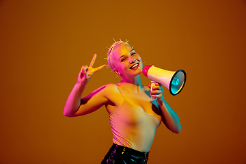 Image showing Portrait of young caucasian woman in fashionable eyewear on brown background with copyspace, unusual and freaky appearance