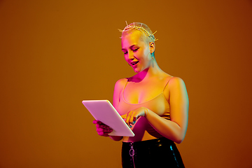 Image showing Portrait of young caucasian woman in fashionable eyewear on brown background with copyspace, unusual and freaky appearance