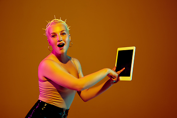 Image showing Portrait of young caucasian woman in fashionable eyewear on brown background with copyspace, unusual and freaky appearance