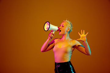 Image showing Portrait of young caucasian woman in fashionable eyewear on brown background with copyspace, unusual and freaky appearance