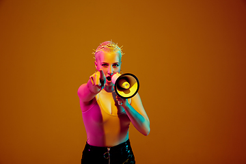 Image showing Portrait of young caucasian woman in fashionable eyewear on brown background with copyspace, unusual and freaky appearance