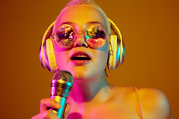 Image showing Portrait of young caucasian woman in fashionable eyewear on brown background with copyspace, unusual and freaky appearance