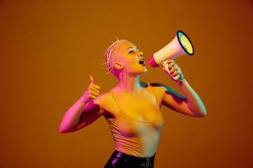 Image showing Portrait of young caucasian woman in fashionable eyewear on brown background with copyspace, unusual and freaky appearance