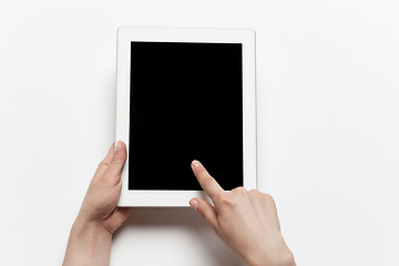 Image showing Close up of human hand using tablet with blank black screen, education and business concept