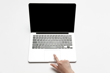 Image showing Close up of human hand using laptop with blank black screen, education and business concept