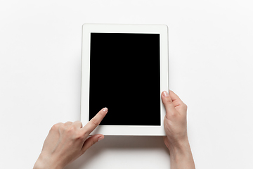 Image showing Close up of human hand using tablet with blank black screen, education and business concept