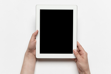 Image showing Close up of human hand using tablet with blank black screen, education and business concept