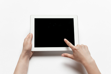 Image showing Close up of human hand using tablet with blank black screen, education and business concept