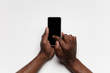 Image showing Close up of human hand using smartphone with blank black screen, education and business concept