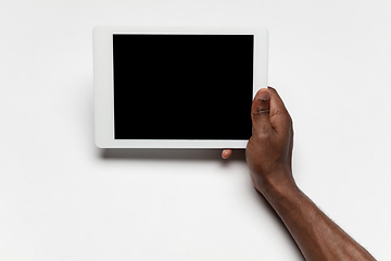 Image showing Close up of human hand using tablet with blank black screen, education and business concept