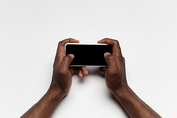 Image showing Close up of human hand using smartphone with blank black screen, education and business concept