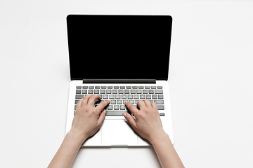 Image showing Close up of human hand using laptop with blank black screen, education and business concept