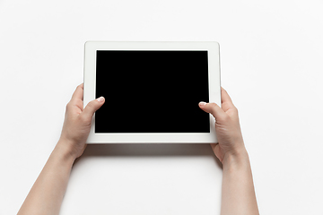 Image showing Close up of human hand using tablet with blank black screen, education and business concept