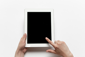Image showing Close up of human hand using tablet with blank black screen, education and business concept