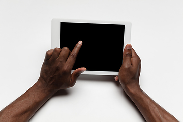 Image showing Close up of human hand using tablet with blank black screen, education and business concept