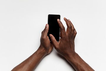 Image showing Close up of human hand using smartphone with blank black screen, education and business concept