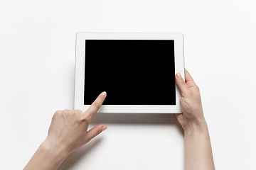 Image showing Close up of human hand using tablet with blank black screen, education and business concept