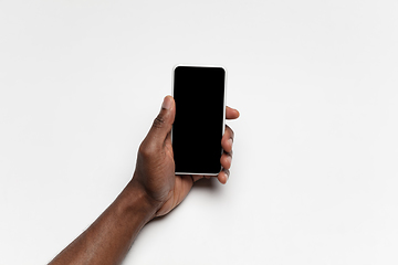 Image showing Close up of human hand using smartphone with blank black screen, education and business concept