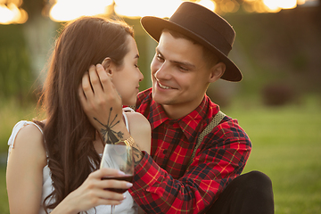 Image showing Caucasian young and happy couple enjoying a picnic in the park on summer day