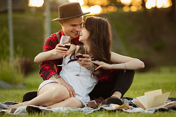 Image showing Caucasian young and happy couple enjoying a picnic in the park on summer day