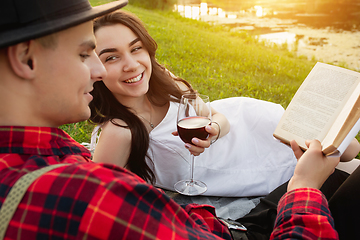 Image showing Caucasian young and happy couple enjoying a picnic in the park on summer day