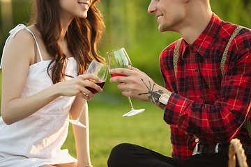 Image showing Caucasian young and happy couple enjoying a picnic in the park on summer day