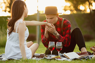 Image showing Caucasian young and happy couple enjoying a picnic in the park on summer day