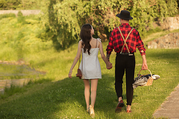 Image showing Caucasian young and happy couple enjoying a picnic in the park on summer day