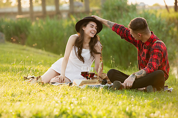 Image showing Caucasian young and happy couple enjoying a picnic in the park on summer day