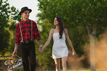 Image showing Caucasian young and happy couple enjoying a picnic in the park on summer day