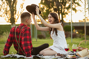 Image showing Caucasian young and happy couple enjoying a picnic in the park on summer day