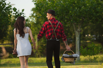 Image showing Caucasian young and happy couple enjoying a picnic in the park on summer day