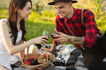 Image showing Caucasian young and happy couple enjoying a picnic in the park on summer day